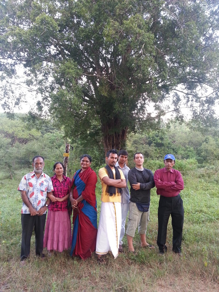 Group photo in front of sacred jungle tree.